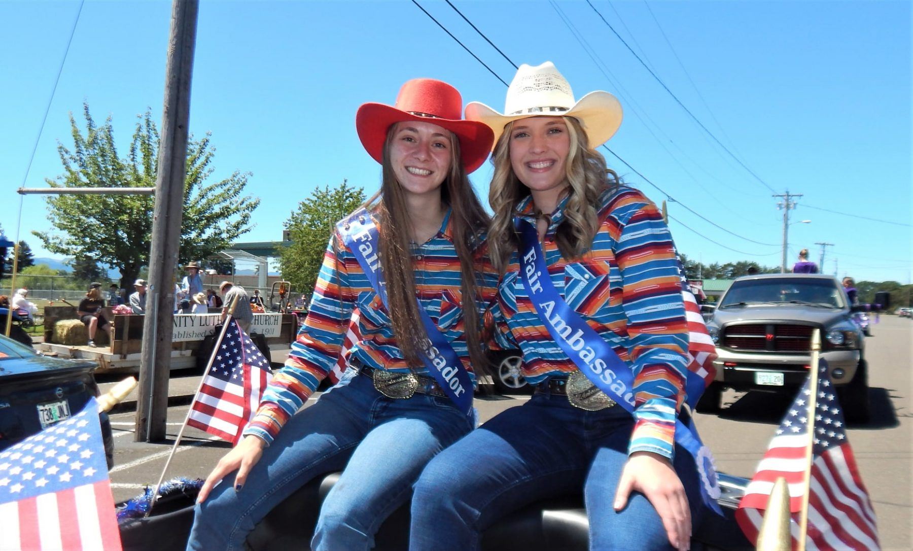 Fair Ambassadors sitting on top of seats in car